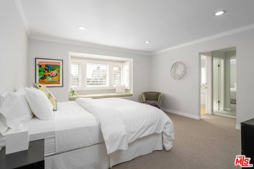 3104 Hutton Drive Beverly Hills, CA 90210 - Photo 22 of 37 a bedroom with a bed a painting on the wall and a window