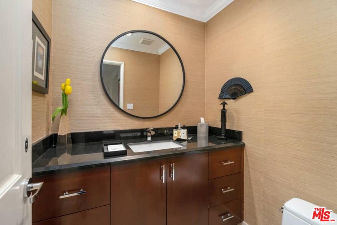 3104 Hutton Drive Beverly Hills, CA 90210 - Photo 4 of 37 a bathroom with a sink and a mirror