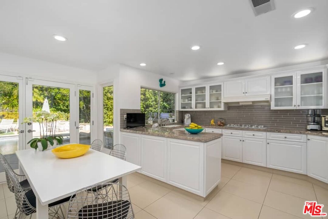 3104 Hutton Drive Beverly Hills, CA 90210 - Photo 9 of 37 a kitchen that has a sink and a stove in it