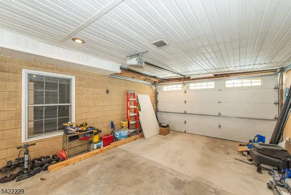 a view of a garage room with wooden walls