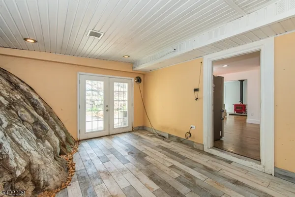 a view of an empty room with glass door