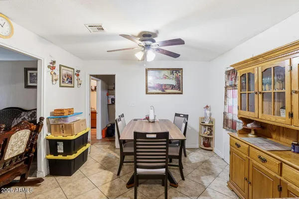 a kitchen that has a table and chairs in it