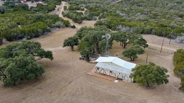 an aerial view of a house with a yard