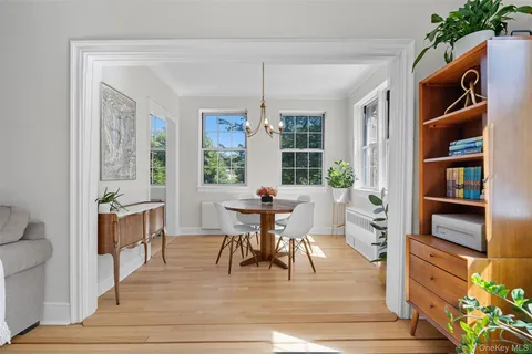 a dining room with furniture and window