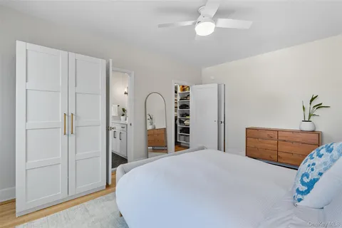 a bedroom with a large bed and a window