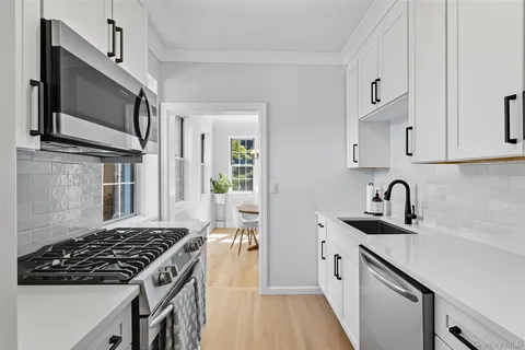 a kitchen with stainless steel appliances a stove a microwave and a refrigerator