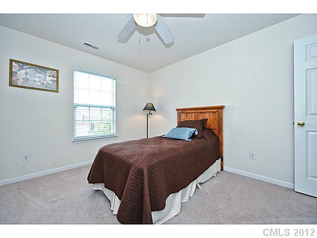 5518 Alexandrite Way Fort Mill, SC 29708 - Photo 14 of 16 a bedroom with a bed and a window
