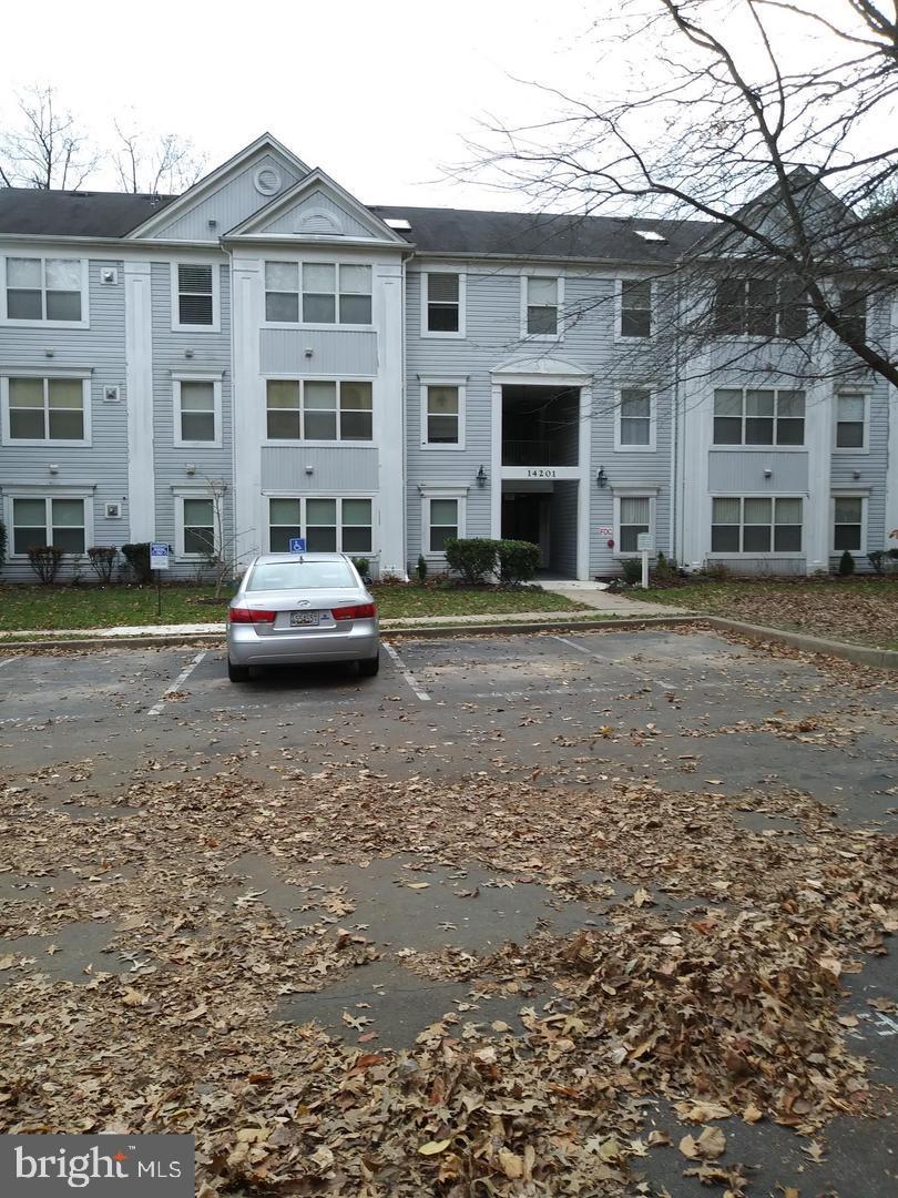 a car parked in front of a brick house