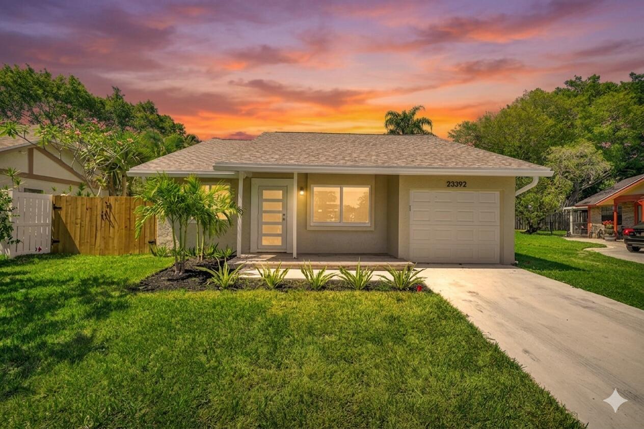 23392 East Country Club Drive East Boca Raton, FL 33428 - Photo 1 of 21 a front view of a house with a yard