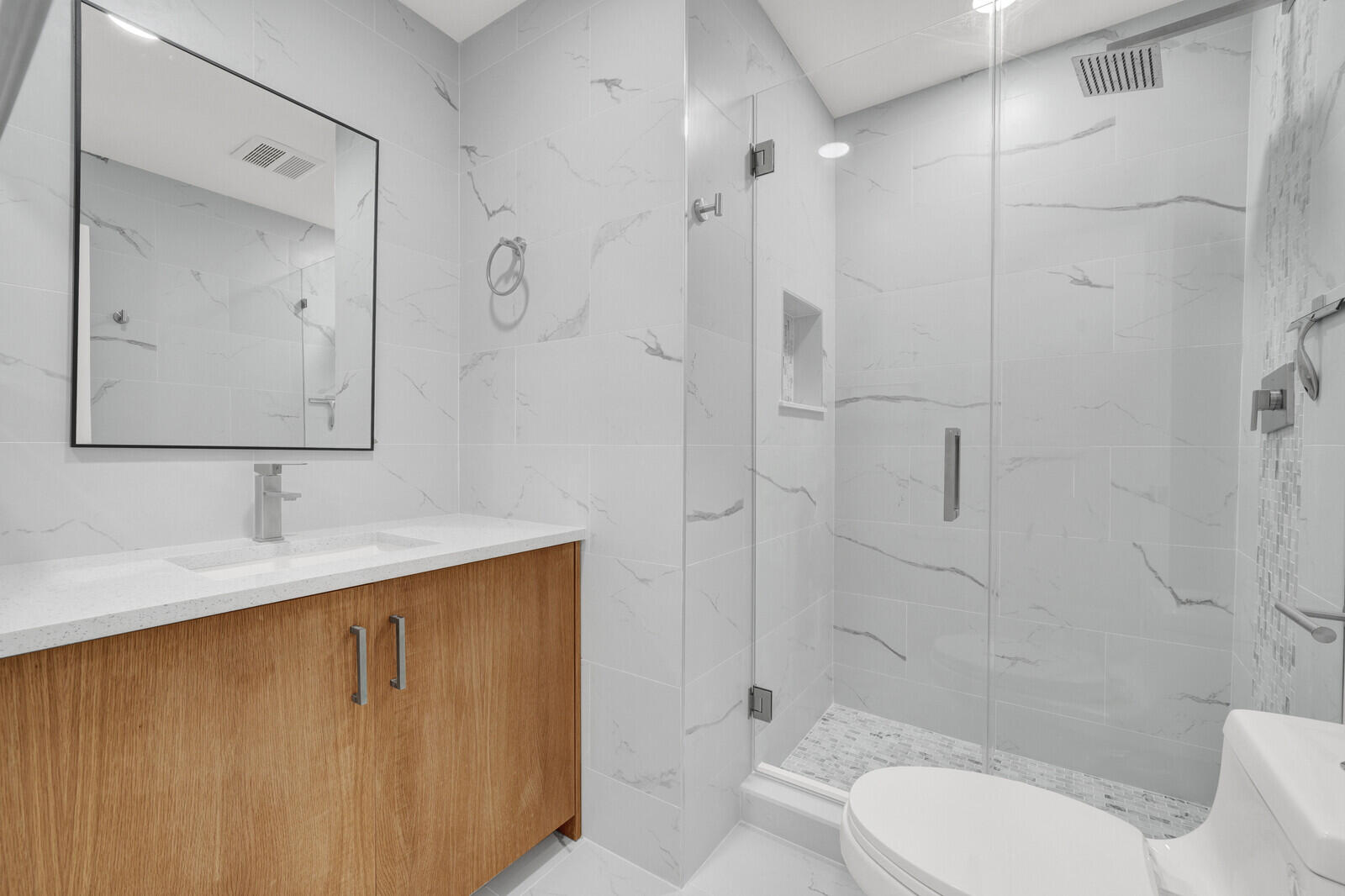 23392 East Country Club Drive East Boca Raton, FL 33428 - Photo 18 of 21 a bathroom with a granite countertop sink toilet and shower