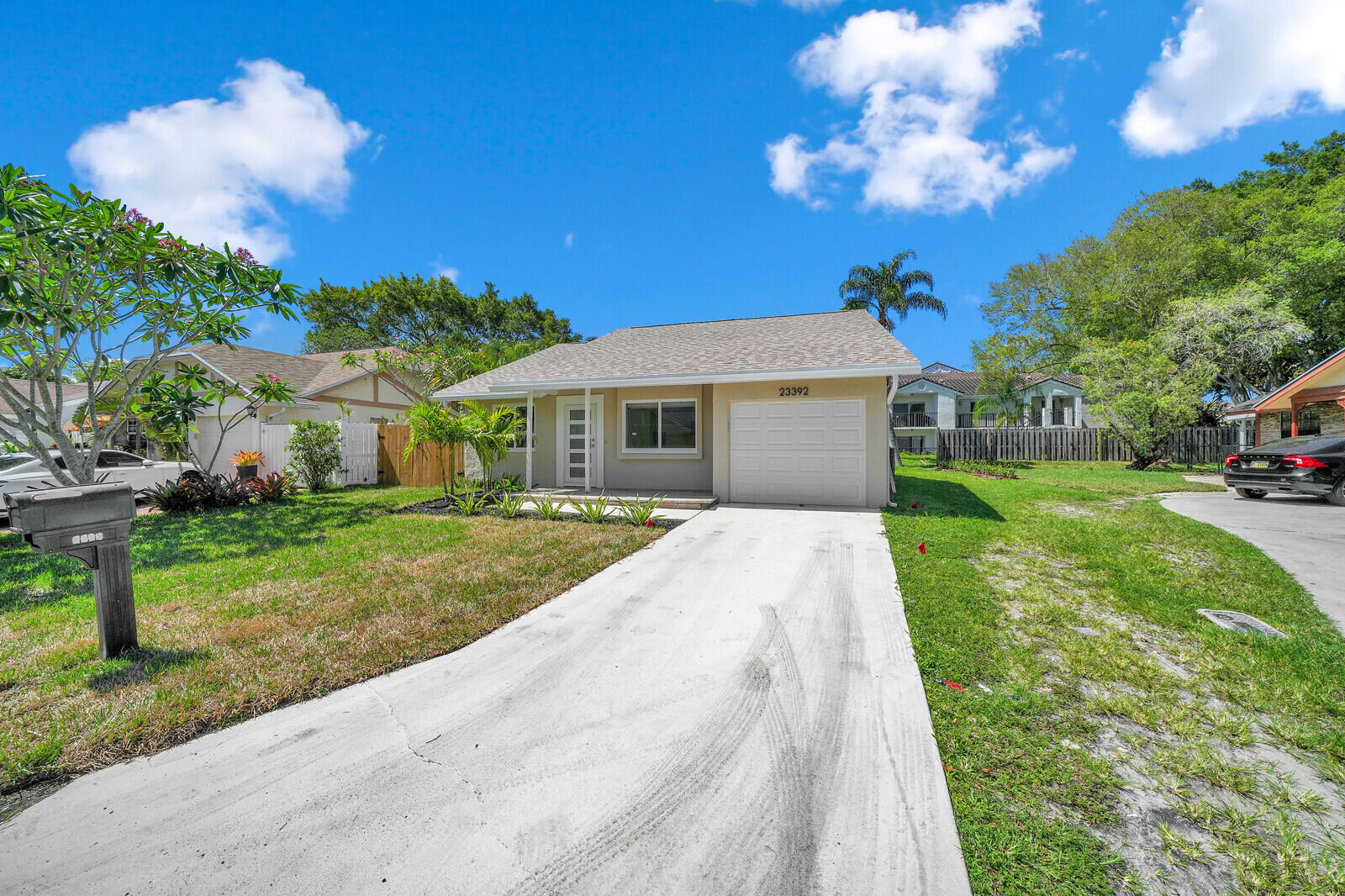 23392 East Country Club Drive East Boca Raton, FL 33428 - Photo 19 of 21 a front view of a house with garden