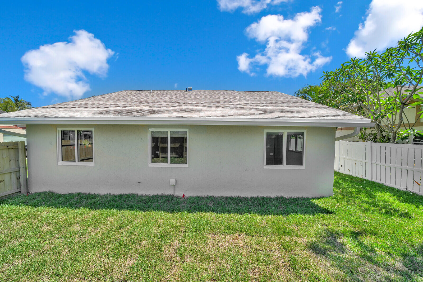 23392 East Country Club Drive East Boca Raton, FL 33428 - Photo 20 of 21 a front view of house with yard