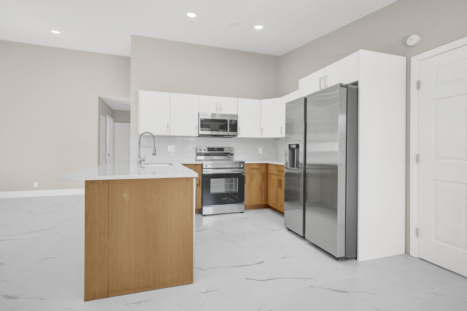 23392 East Country Club Drive East Boca Raton, FL 33428 - Photo 8 of 21 a kitchen with stainless steel appliances a refrigerator and a stove top oven
