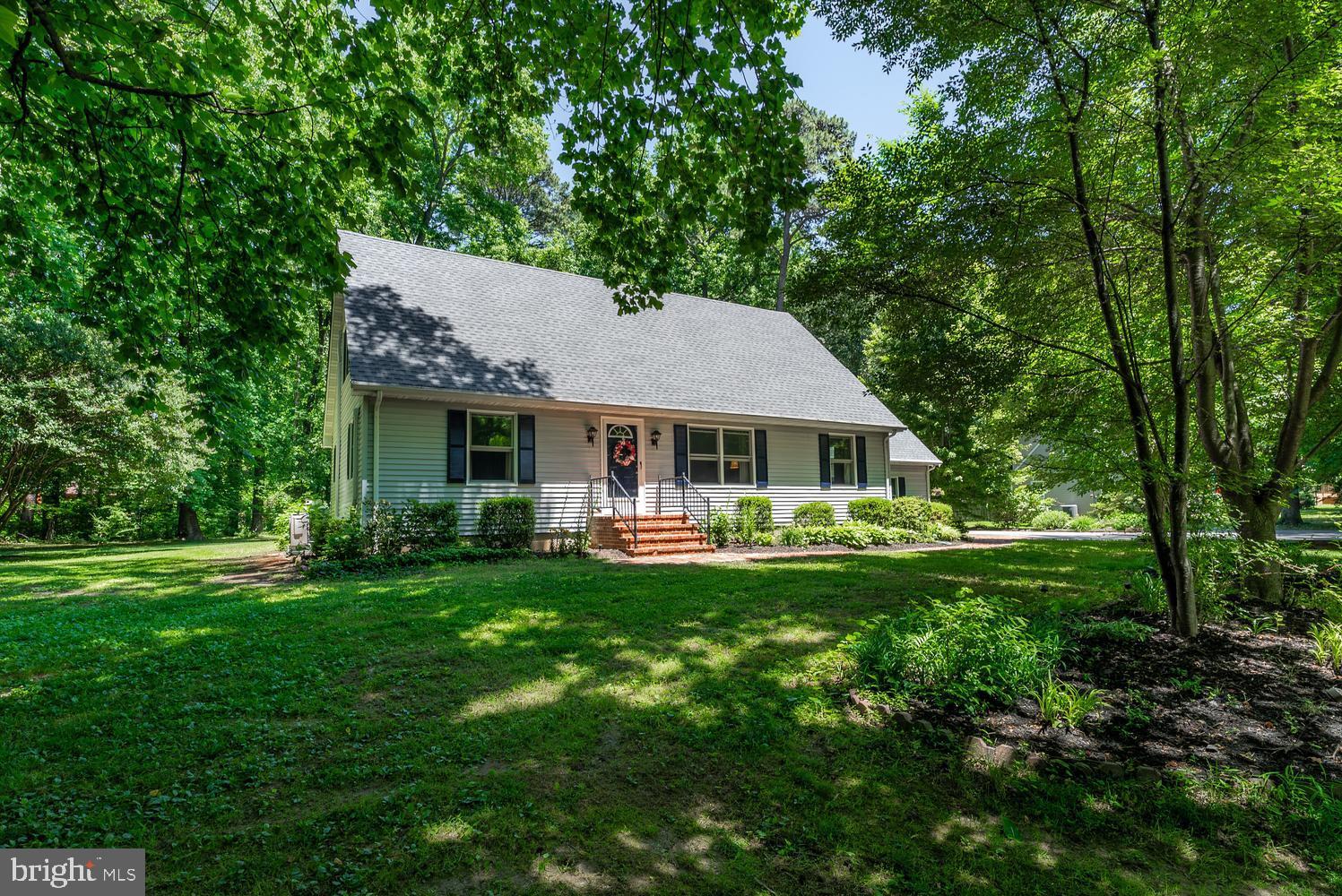 814 Wrights Neck Road Centreville, MD 21617 - Photo 1 of 53 a front view of a house with yard and green space
