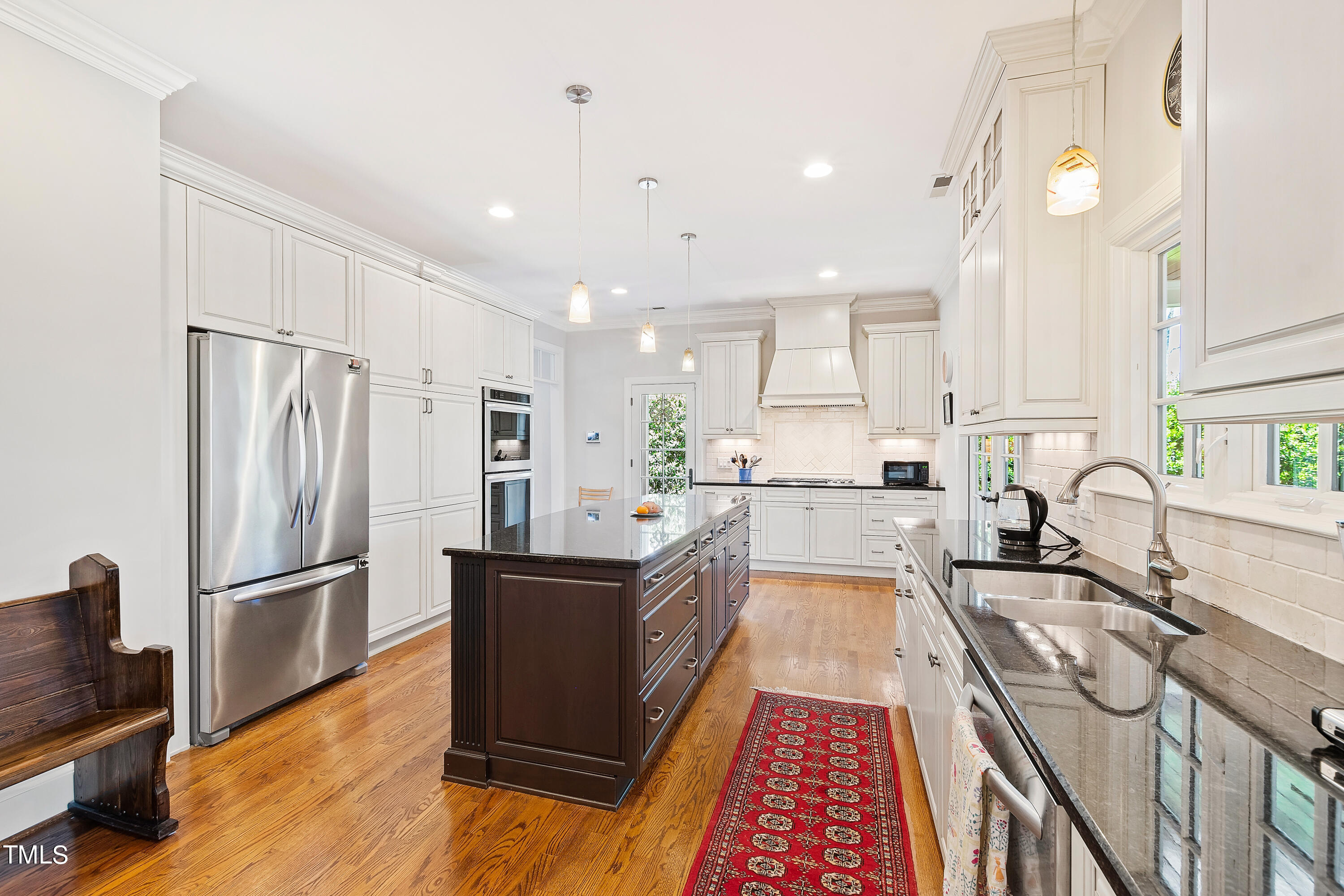 2210 Coley Forest Place Raleigh, NC 27607 - Photo 18 of 44 a large kitchen with stainless steel appliances granite countertop a refrigerator and a sink