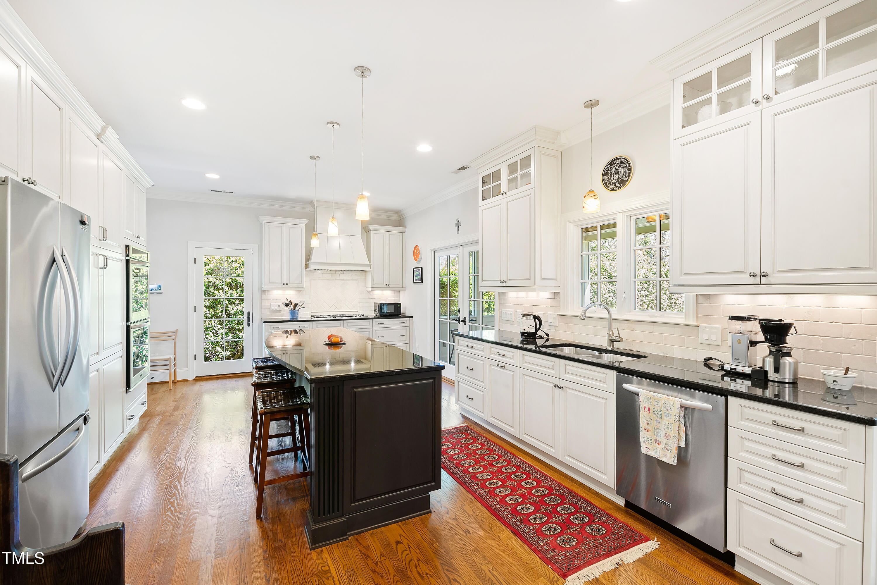 2210 Coley Forest Place Raleigh, NC 27607 - Photo 2 of 44 a kitchen with stainless steel appliances granite countertop a sink a stove and a refrigerator