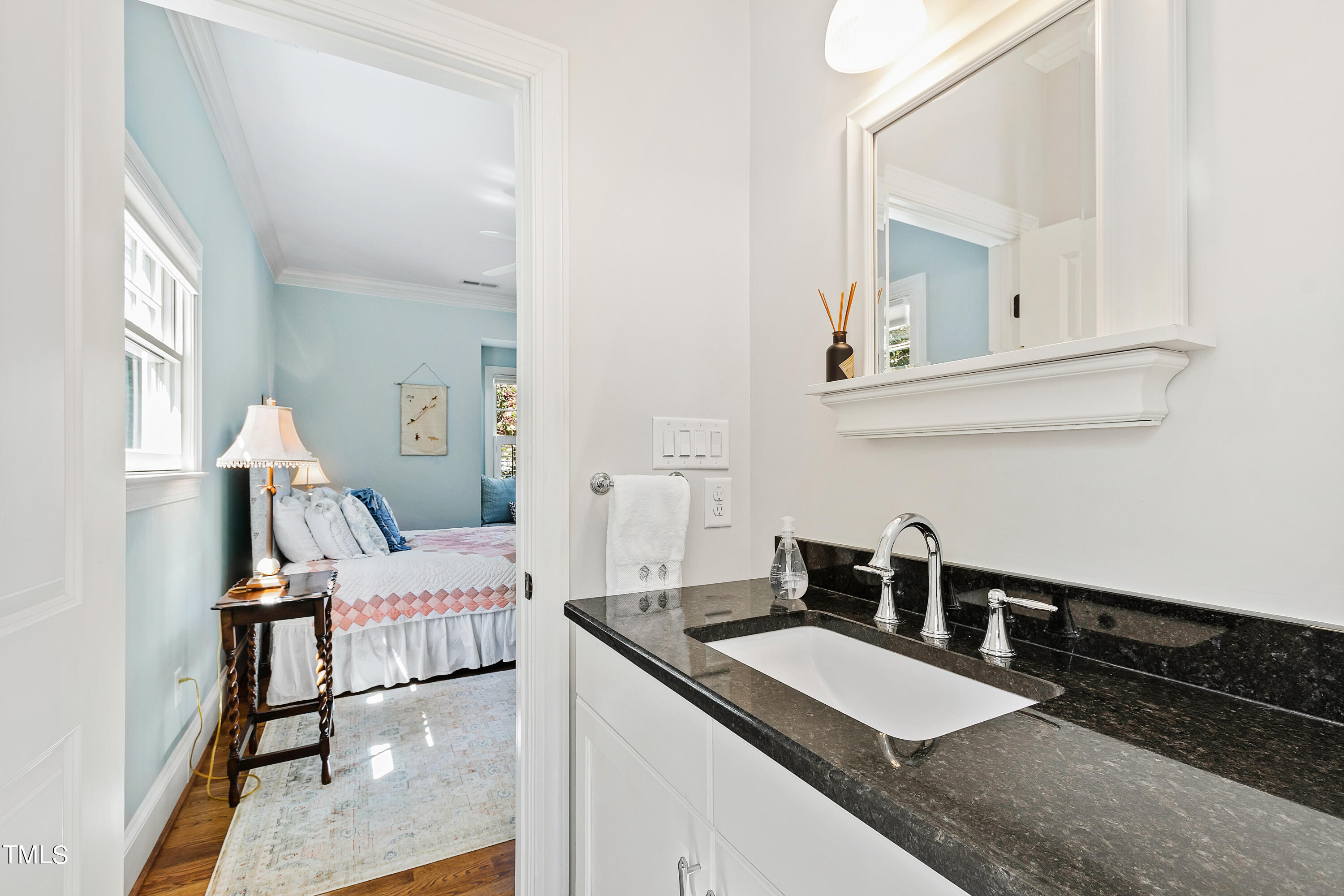 2210 Coley Forest Place Raleigh, NC 27607 - Photo 32 of 44 a kitchen with granite countertop a sink and a stove top oven with wooden floor