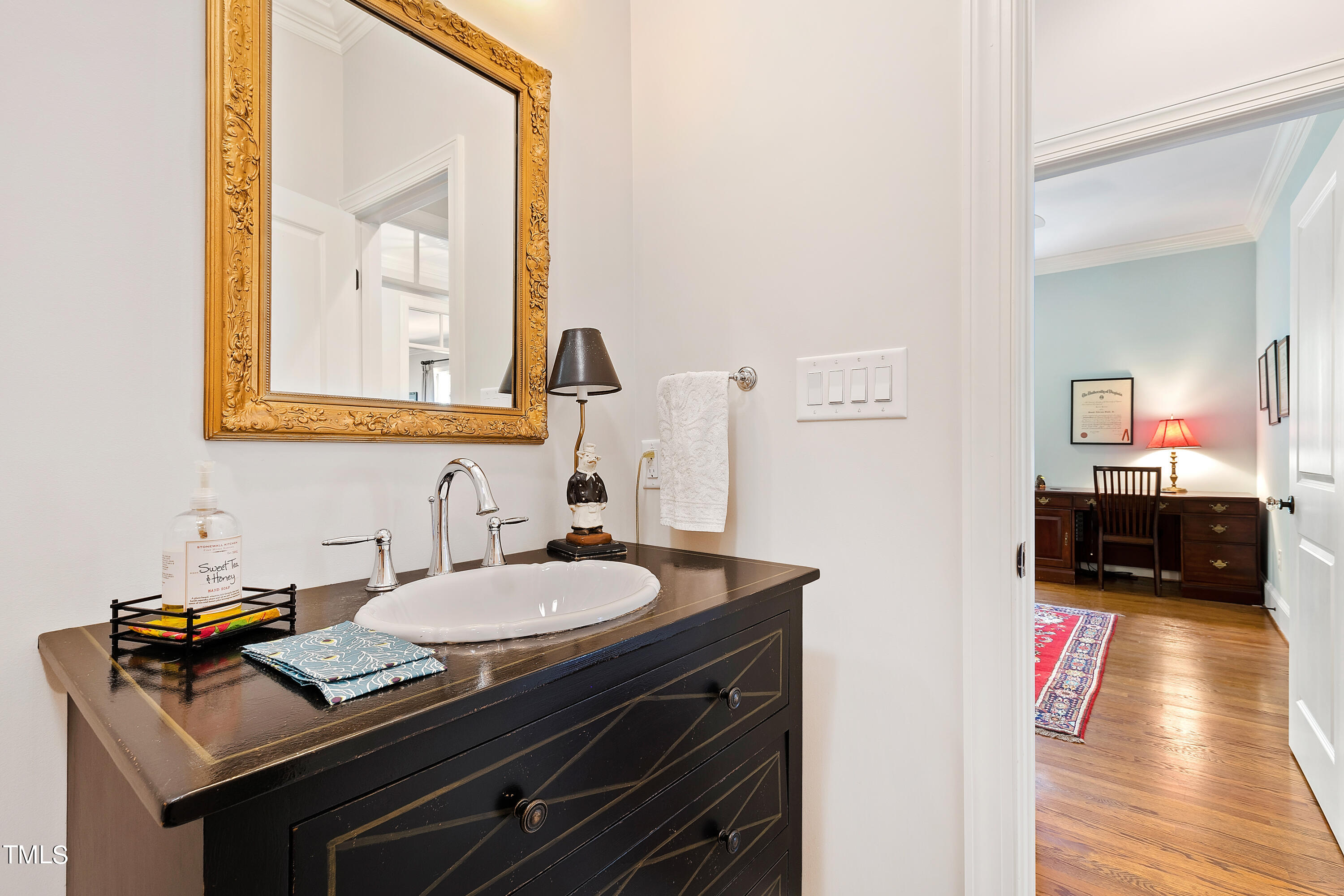 2210 Coley Forest Place Raleigh, NC 27607 - Photo 36 of 44 a bathroom with a sink and a mirror