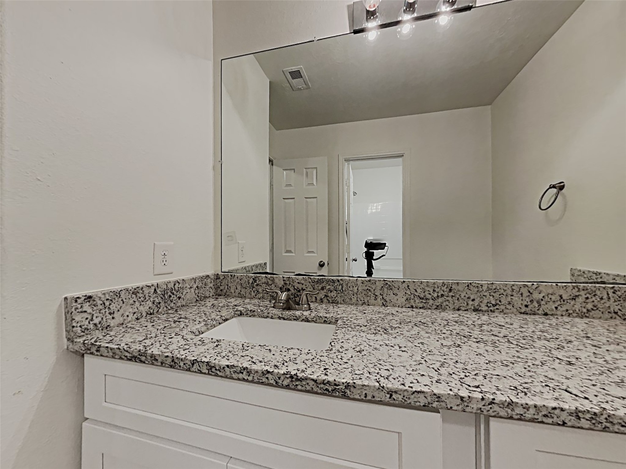 21619 Ornella Circle Humble, TX 77338 - Photo 16 of 18 a bathroom with a granite countertop sink and a mirror