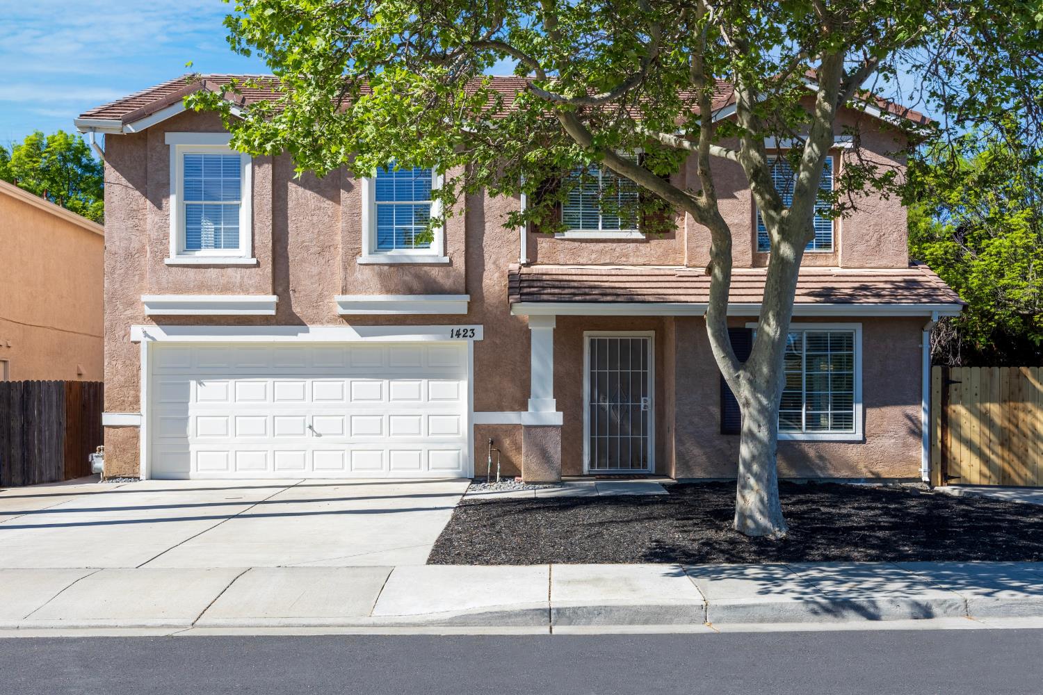 1423 Sienna Park Drive Tracy, CA 95376 - Photo 1 of 1 a front view of a house with a yard