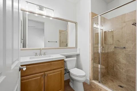 a bathroom with a sink a toilet and shower