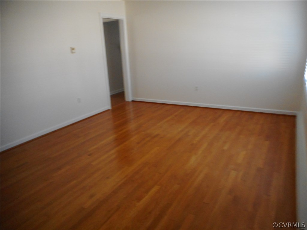 911 Jamestown Road Colonial Heights, VA 23834 - Photo 4 of 17 an empty room with wooden floor and door