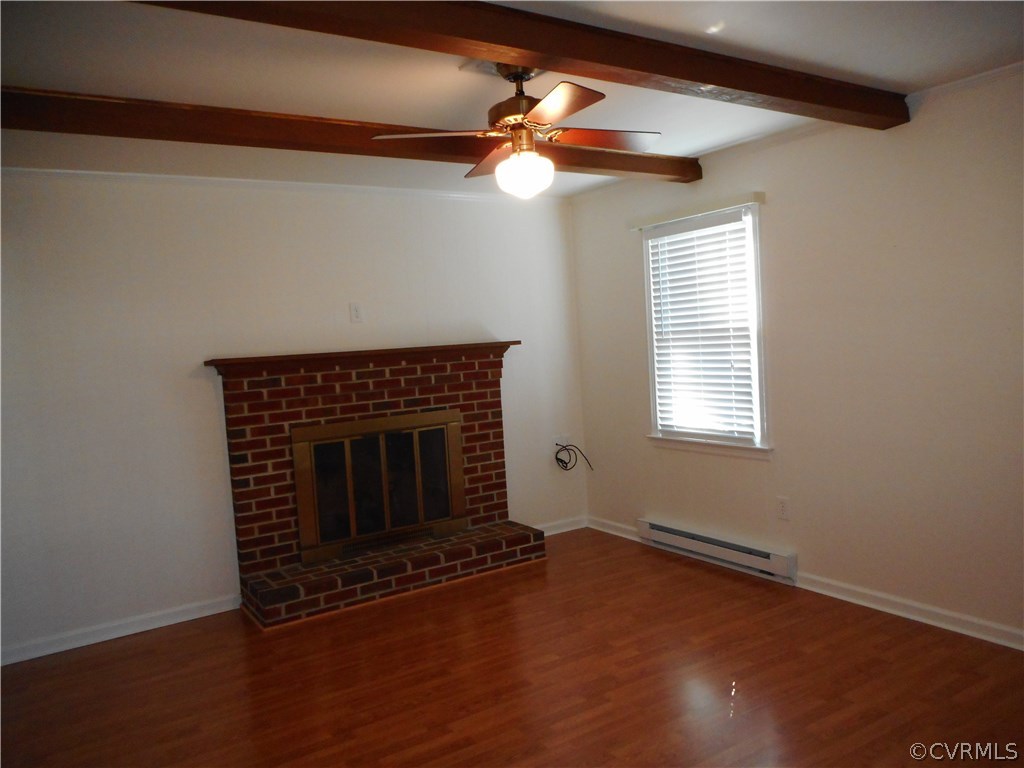 911 Jamestown Road Colonial Heights, VA 23834 - Photo 9 of 17 a view of an empty room with wooden floor fireplace and a window