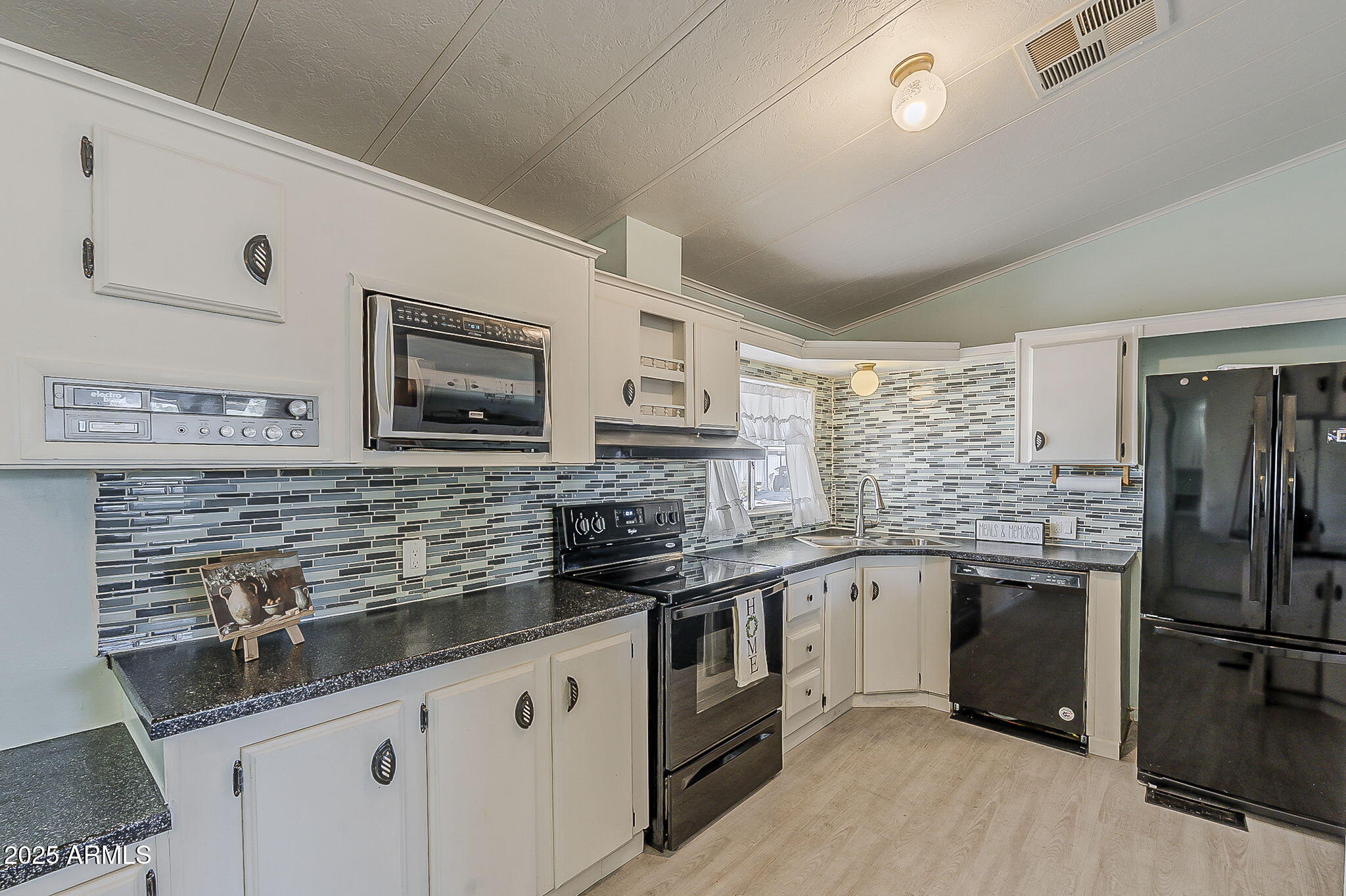834 South Meridian Road, Unit 118 Apache Junction, AZ 85120 - Photo 4 of 50 a kitchen with stainless steel appliances granite countertop a sink stove microwave and refrigerator