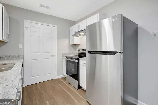 a kitchen with a refrigerator and a sink
