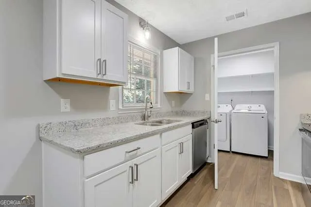a kitchen with white cabinets and a sink