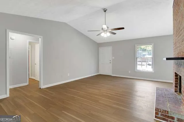 wooden floor in an empty room with a window