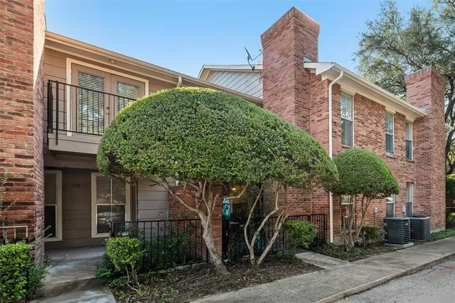a front view of a house with plants