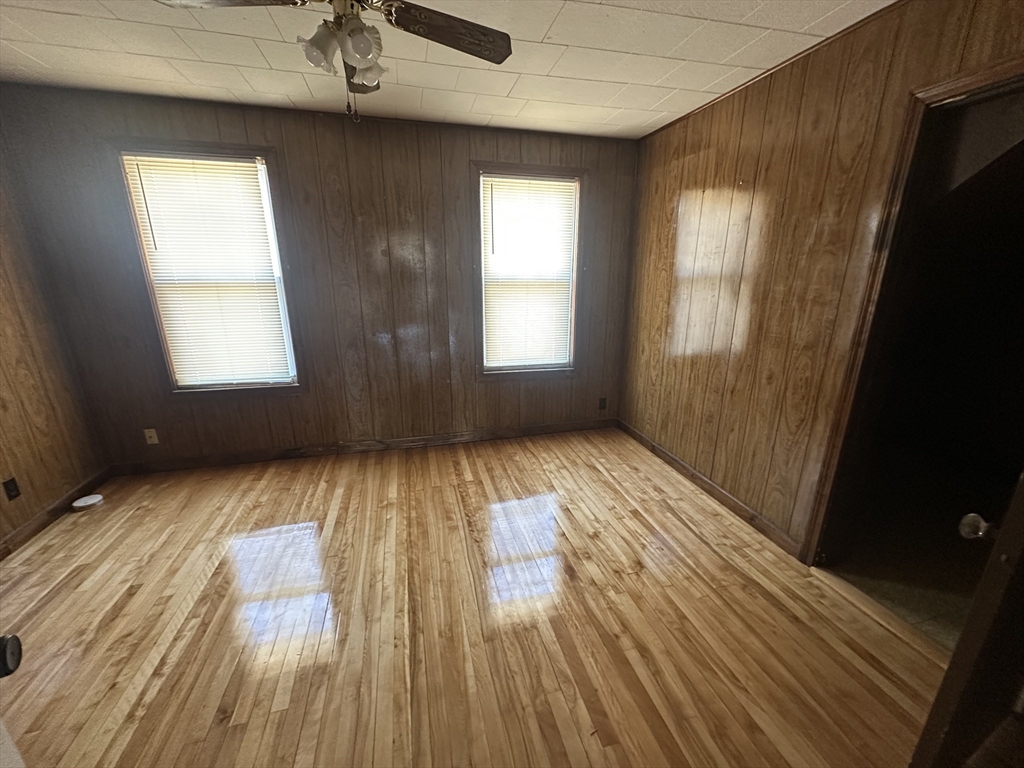 242 Greenwood Street Worcester, MA 01607 - Photo 5 of 10 an empty room with wooden floor and windows