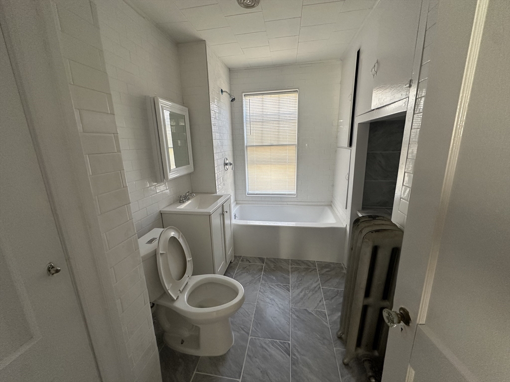 242 Greenwood Street Worcester, MA 01607 - Photo 8 of 10 a bathroom with a toilet and a sink