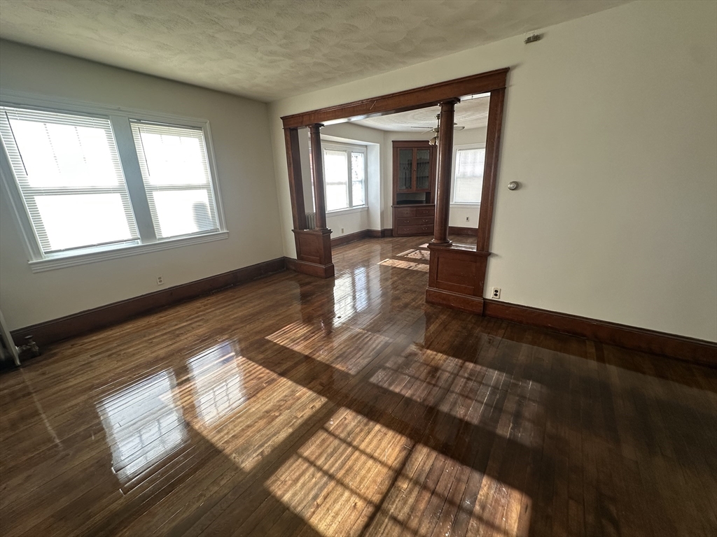 242 Greenwood Street Worcester, MA 01607 - Photo 9 of 10 a view of an empty room with wooden floor and a window