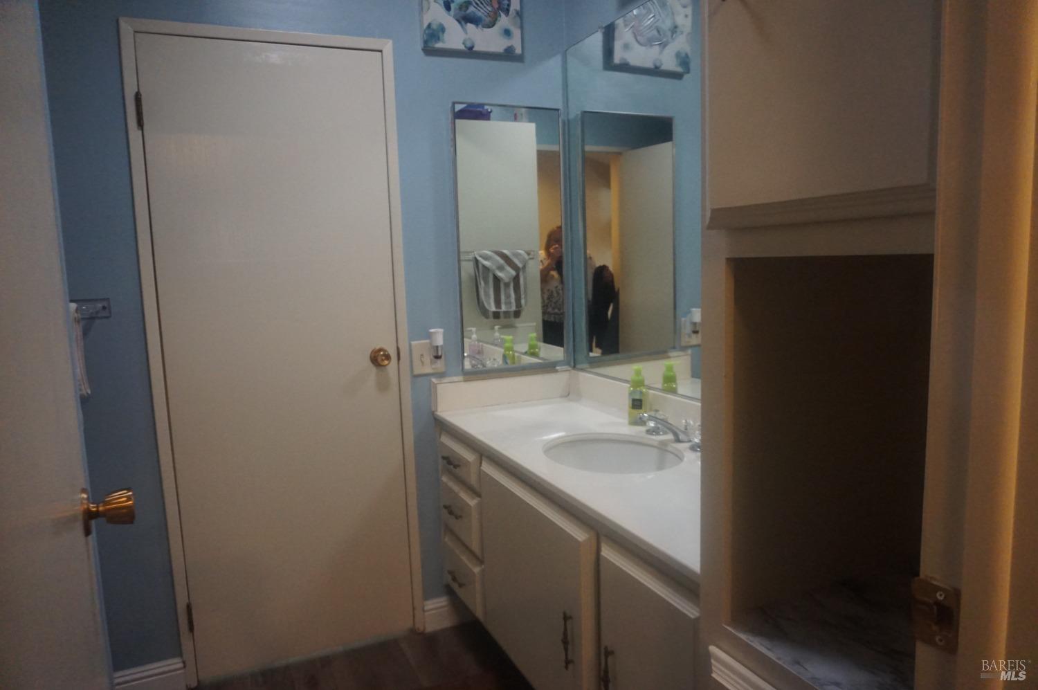 6004 Monticello Road, Unit 10 Napa, CA 94558 - Photo 22 of 41 a bathroom with a granite countertop sink and a mirror