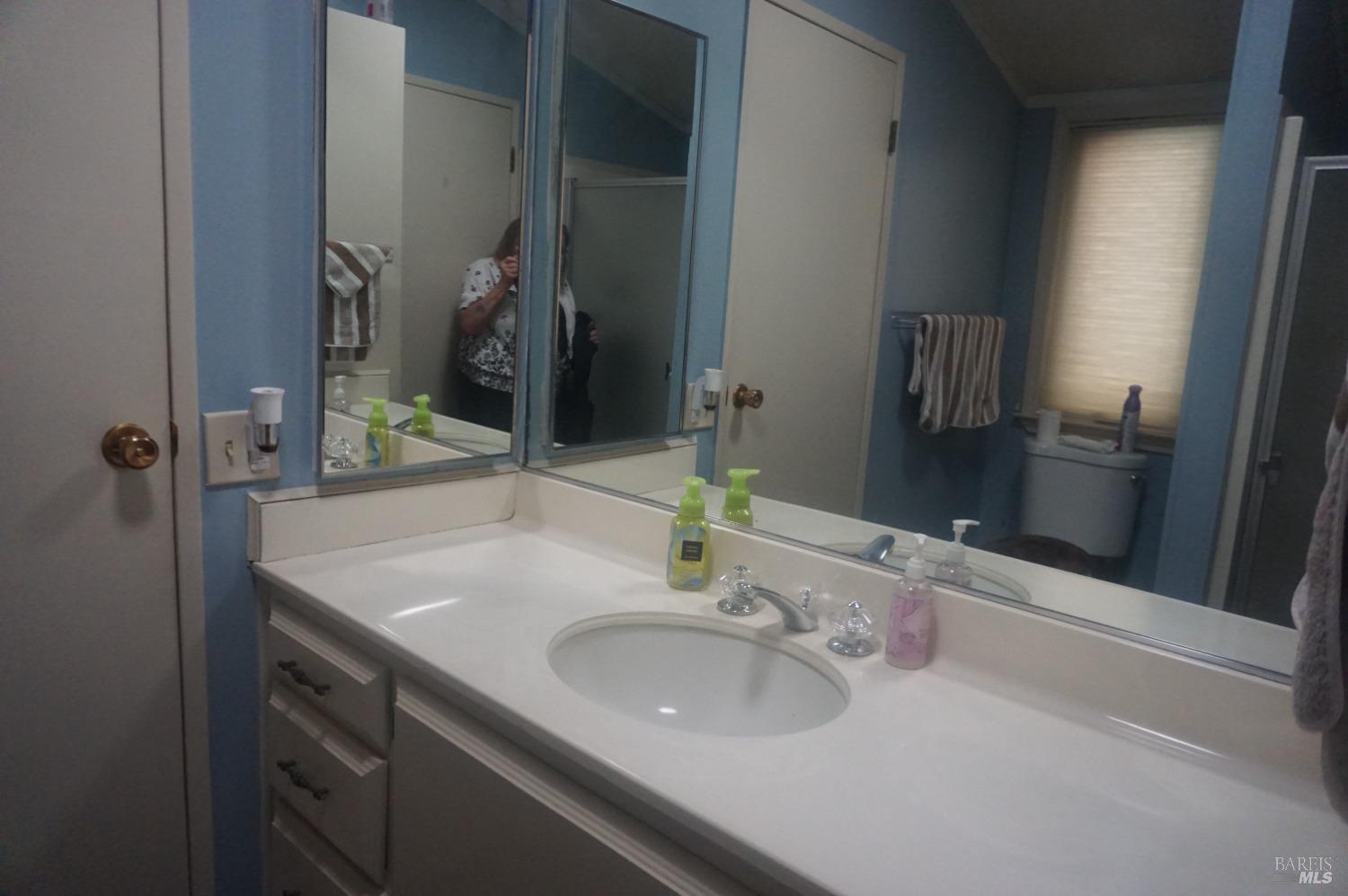 6004 Monticello Road, Unit 10 Napa, CA 94558 - Photo 25 of 41 a bathroom with a sink and a mirror