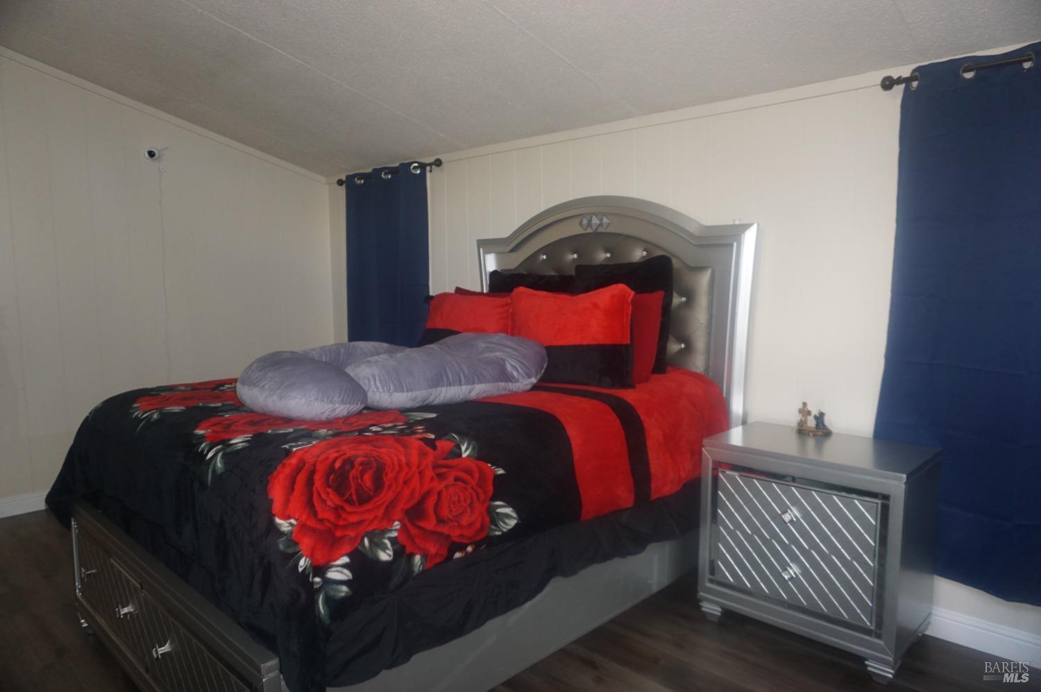 6004 Monticello Road, Unit 10 Napa, CA 94558 - Photo 32 of 41 a bedroom with a bed and dresser