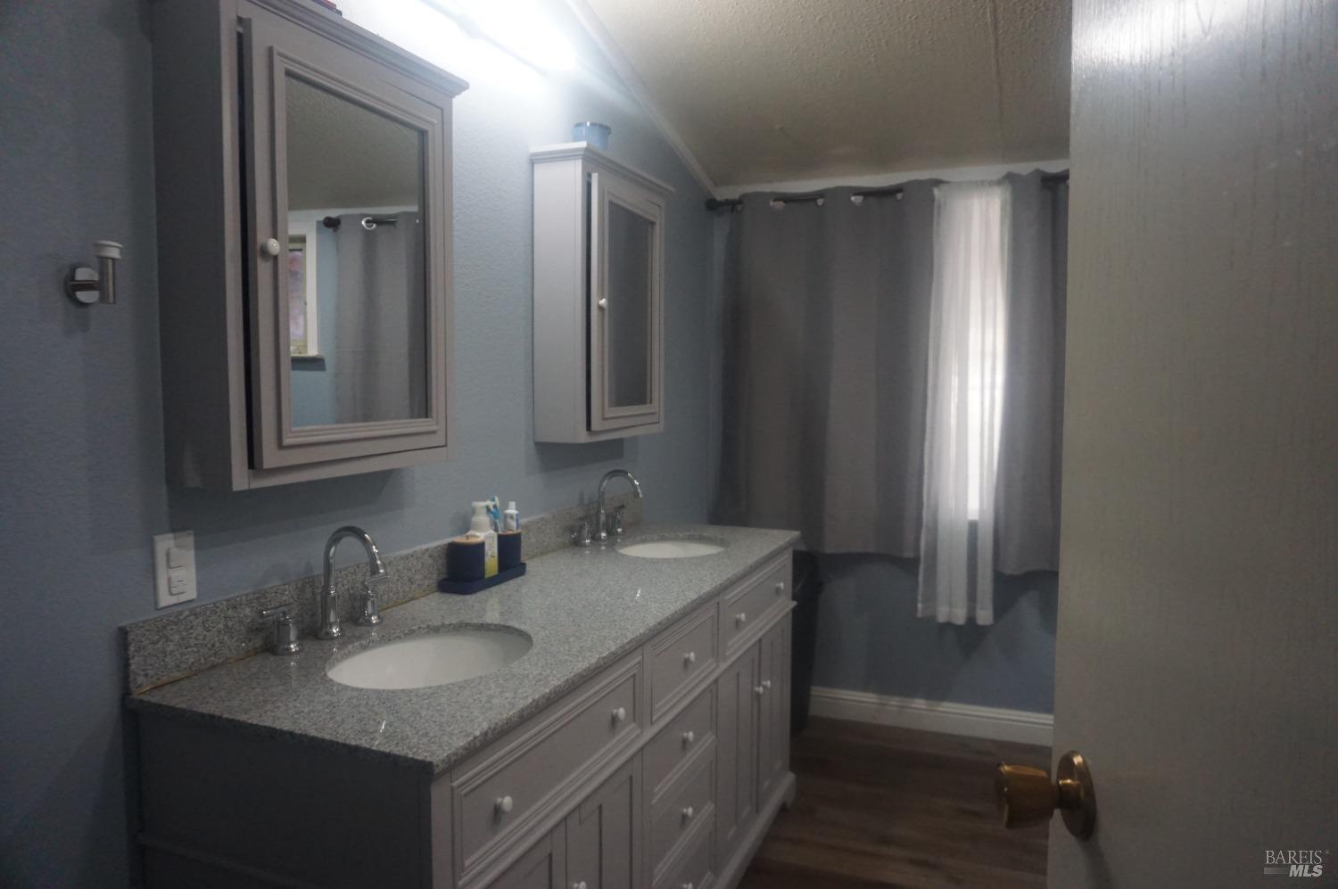 6004 Monticello Road, Unit 10 Napa, CA 94558 - Photo 34 of 41 a bathroom with 2 sink and a mirror