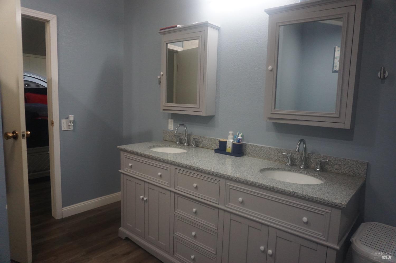 6004 Monticello Road, Unit 10 Napa, CA 94558 - Photo 37 of 41 a bathroom with a granite countertop sink a mirror and