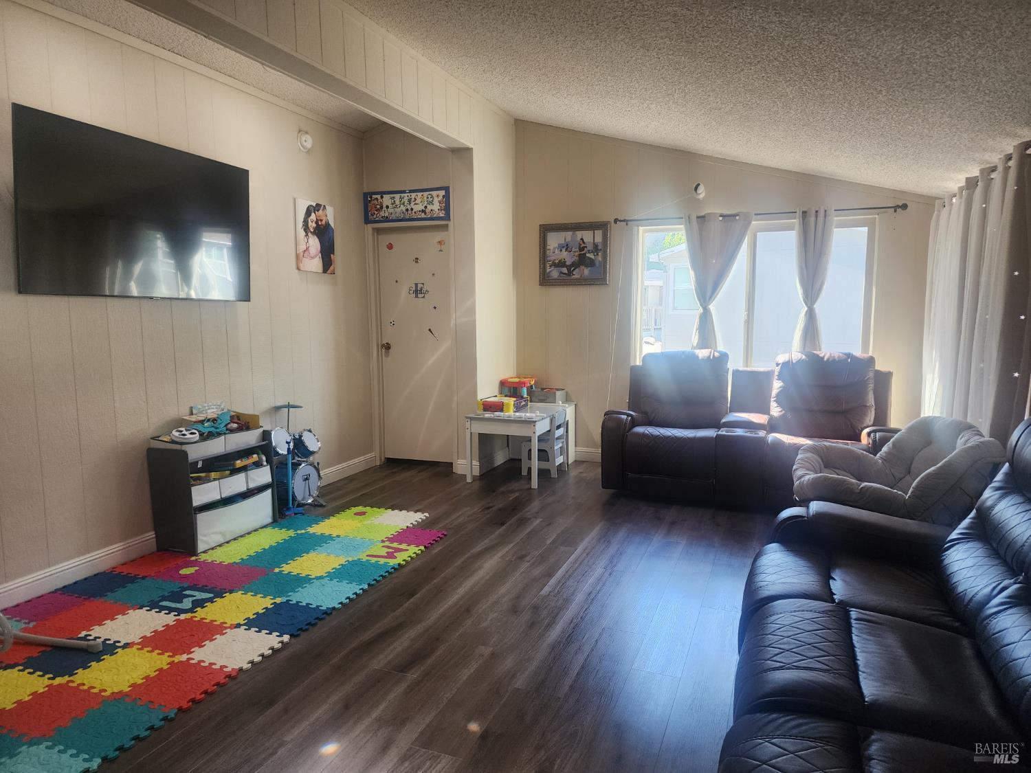 6004 Monticello Road, Unit 10 Napa, CA 94558 - Photo 4 of 41 a living room with furniture and a flat screen tv