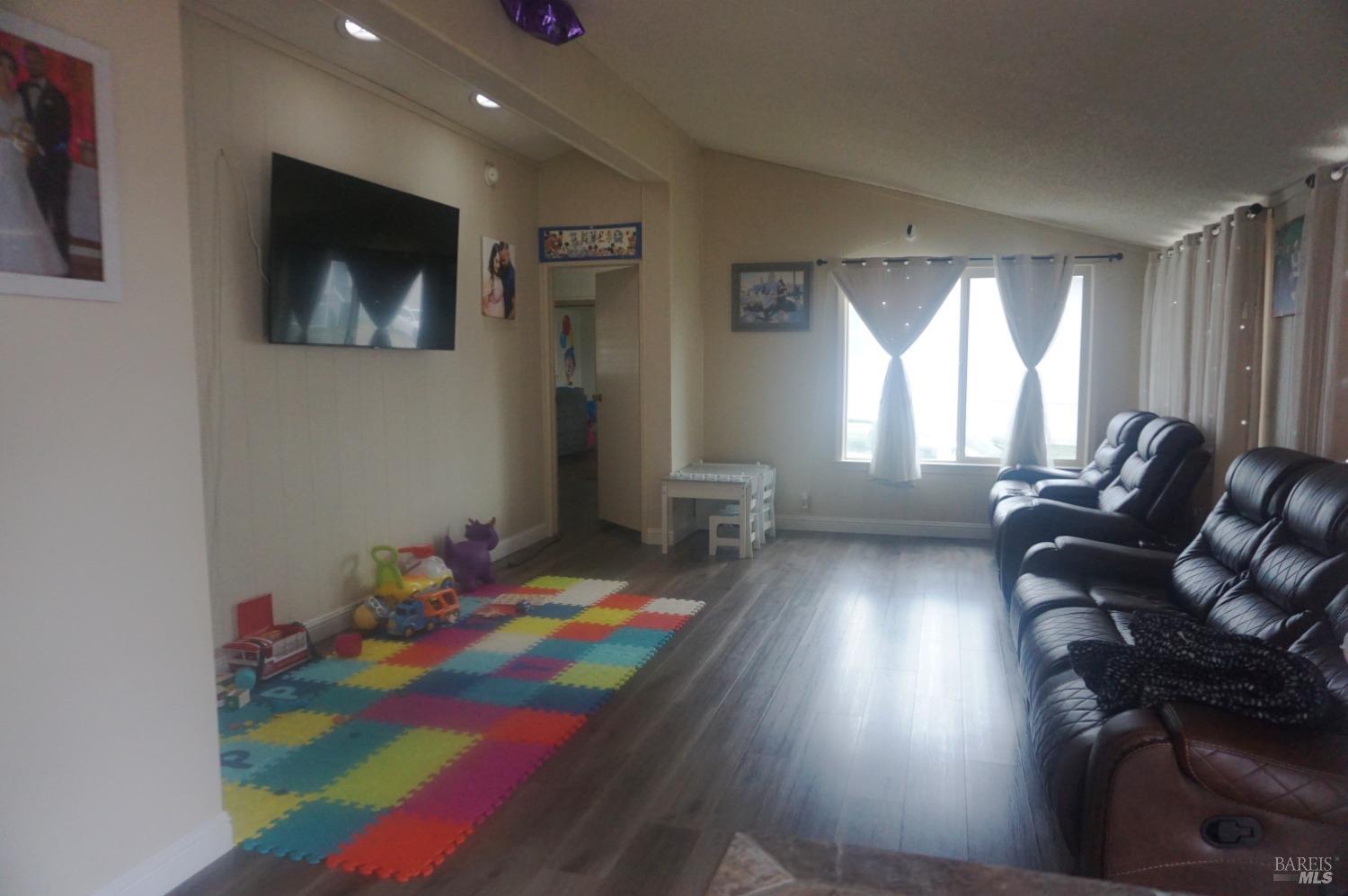 6004 Monticello Road, Unit 10 Napa, CA 94558 - Photo 6 of 41 a living room with furniture and a flat screen tv