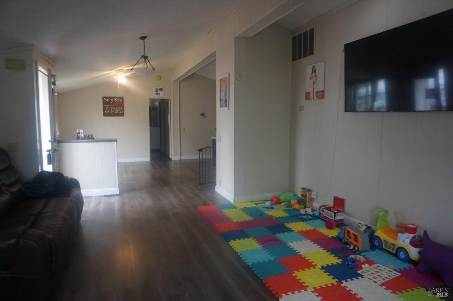 6004 Monticello Road, Unit 10 Napa, CA 94558 - Photo 7 of 41 a room with lots of baby toys and wooden floor