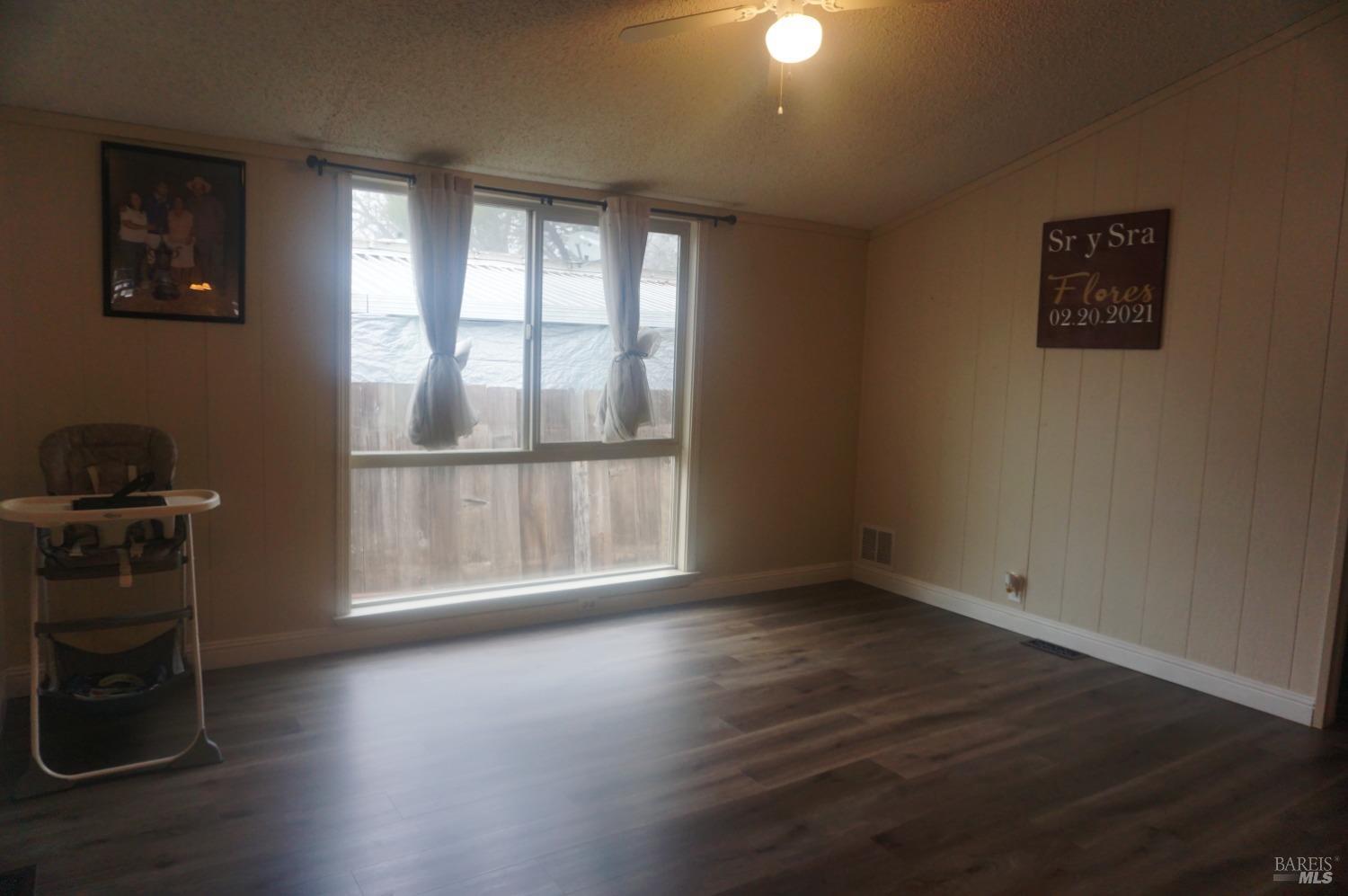 6004 Monticello Road, Unit 10 Napa, CA 94558 - Photo 9 of 41 an empty room with wooden floor and windows