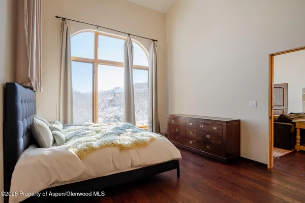 a bed sitting in a bedroom next to a window