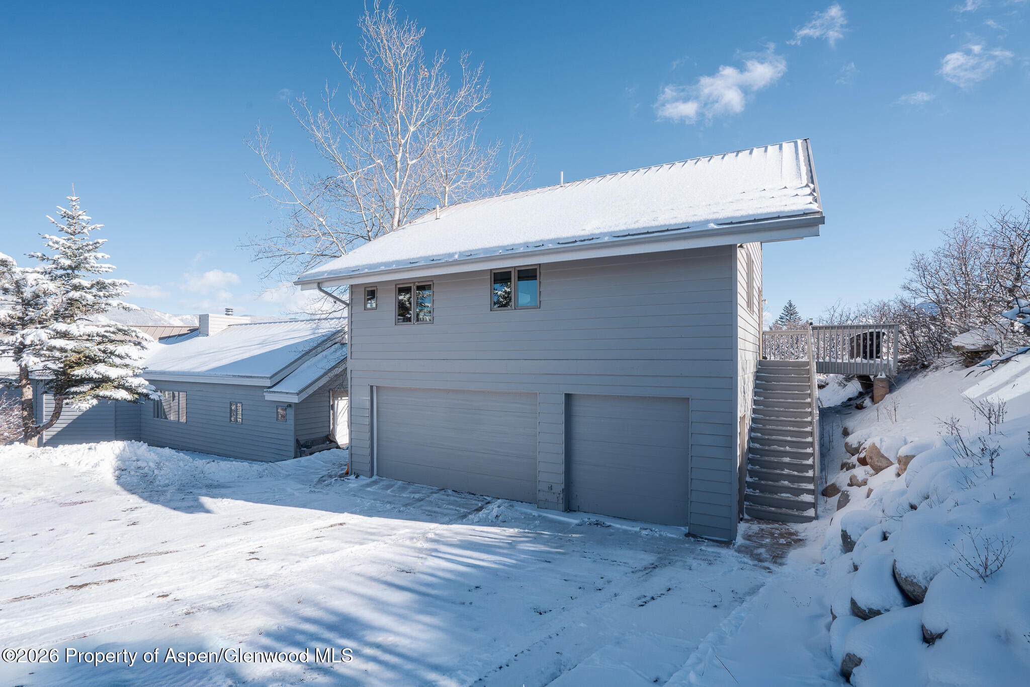 2310 Juniper Hill Road Aspen, CO 81611 - Photo 17 of 18 a front view of a house with a yard and garage