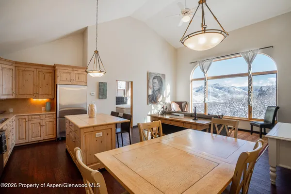 a kitchen with a stove a refrigerator and a table