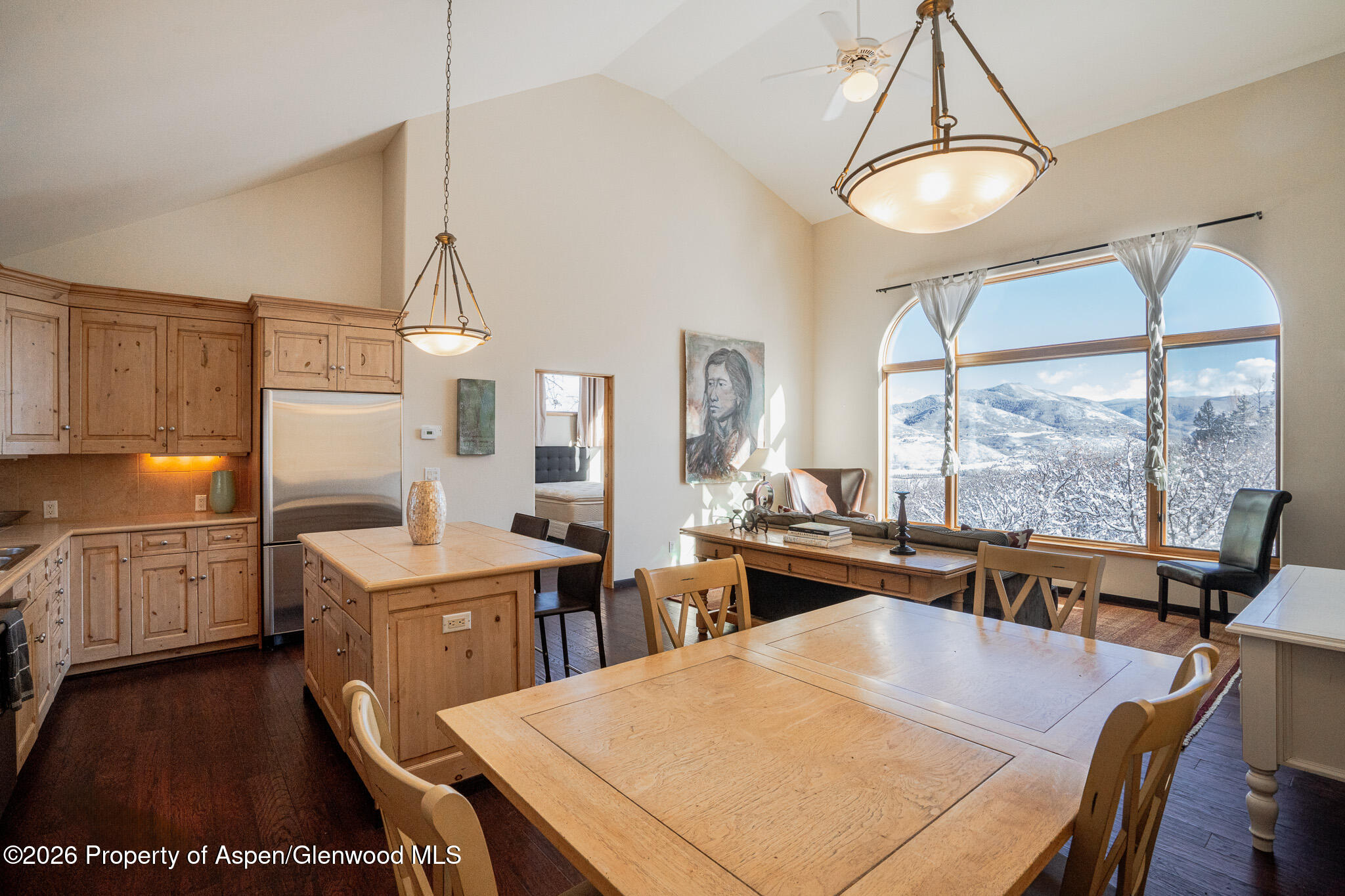 2310 Juniper Hill Road Aspen, CO 81611 - Photo 38 of 50 a kitchen with a stove a refrigerator and a dining table with wooden floor
