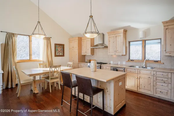 a kitchen with a stove a counter space a sink and cabinets