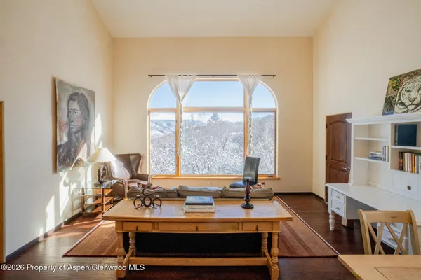 a view of a livingroom with furniture and a large window